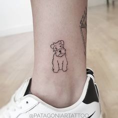 a small dog is on the ankle of a woman's right leg, with a black and white outline