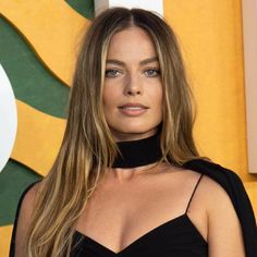 a woman with long hair wearing a black dress