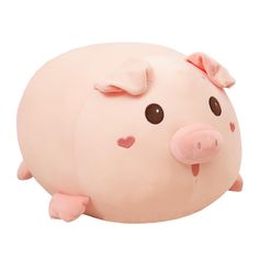 a pink pig pillow sitting on top of a white floor