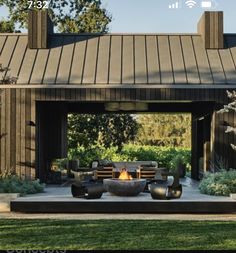 an outdoor fire pit in the middle of a yard