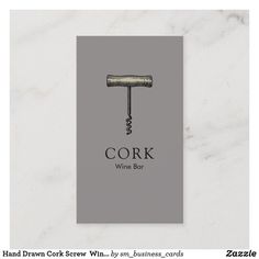 the cork wine bar business card is displayed on a marble surface with an image of a cork