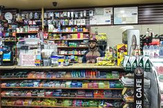 a man standing behind a counter in a store