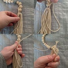 two hands are holding beads and string on a bed sheet with white buttons in the shape of tassels