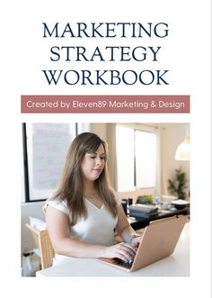 the marketing strategy workbook is open and showing a woman working on her laptop computer