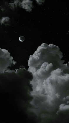 black and white photograph of clouds with the moon in the sky