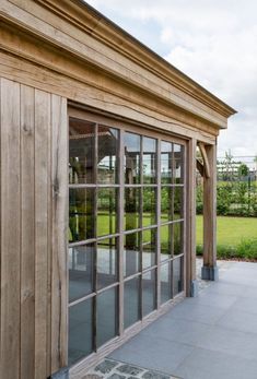 a wooden building with glass doors on the outside