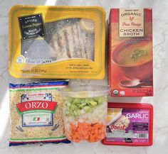 an assortment of food items are displayed on a white tablecloth, including rice, chicken broth, carrots, and noodles