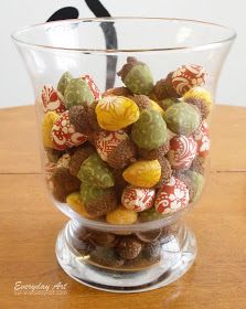 a glass bowl filled with candy on top of a wooden table