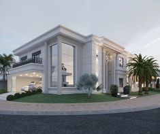 a large white house with palm trees in the front yard