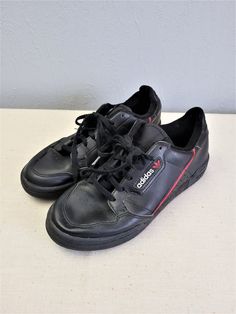 "Black with red and white elements leather lace up women Adidas sneakers. Sport flat shoes. Textile lining inside. Size EU 37. Made in Indonesia. labeled size: EU 37 1/2 / UK 4 1/2 / US 5 / JP 235. Estimated size is EU 37, US 6. condition: normal, used condition. Open a little bit right foot shoe frontal seam, but not practical meaning. measurements: sole heel height 2,5 cm / 0.98\" in outsole length 26 cm / 10.1\" in #s1103" Casual Adidas Logo Custom Lace-up Sneakers, Sporty Lace-up Skate Shoes With Red Sole, Sporty Skate Shoes With Red Sole And Lace-up, Casual Adidas Logo Leather Custom Sneakers, Casual Adidas Logo Leather Sneakers, Custom Black Sneakers With Elastic Laces And Round Toe, Casual Leather Skate Shoes With Red Sole, Leather Low-top Skate Shoes With Red Sole, Casual Adidas Custom Lace-up Sneakers