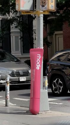 there is a pink tube on the side of the street in front of some cars