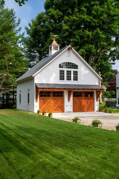 a white house with two garages on the side