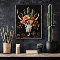 an animal skull with flowers on its head sits in front of cacti and succulents