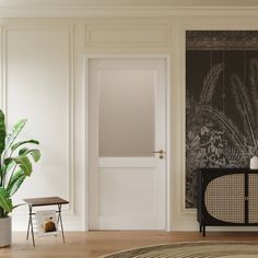 a living room with a plant in the corner and a painting on the wall behind it