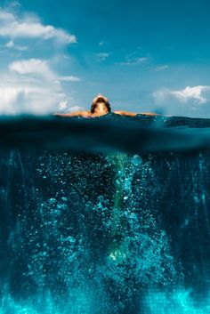 a person swimming in the ocean under water