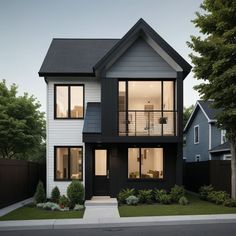 a two story house with black and white siding