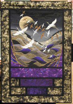 there is a quilt with birds flying over the water