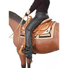 a woman riding on the back of a brown horse