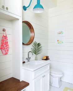 a bathroom with a sink, toilet and mirror