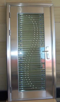 a stainless steel door with glass inserts on it