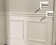 the corner of a room with white paneling and an opening in the wall that has two rolls of toilet paper on it