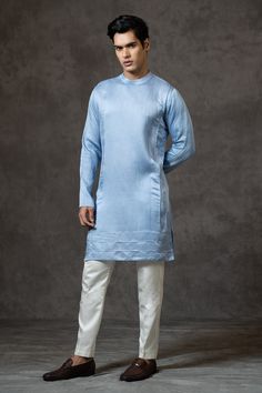 Powder blue line satin kurta with all over pintuck details, band collar and cord piping border. Paired with buttercream malai cotton slim fit pyjama.
Components: 2
Pattern: Pintuck
Neckline: Band Collar
Sleeve Type: Full Sleeves
Fabric: Kurta: Linen Satin, Pyjama: Malai Cotton
Color: Blue
Other Details: 
Shoulder concealed closure
Occasion: Mehendi and Puja,Sangeet - Aza Fashions Satin Kurta, Satin Pyjama, Blue Kurta, Fashion App, Band Collar, Kurta Set, Full Sleeves, Blue Line, Pin Tucks