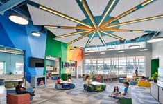 the children's playroom is brightly colored and has lots of seating to sit on