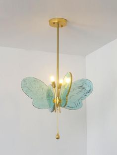 a gold chandelier with blue butterfly wings hanging from the ceiling