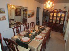 the dining room table is set with plates and place settings for six people to eat