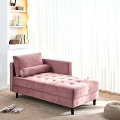 a pink velvet chaise lounger in a living room