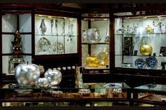 a display case filled with lots of glass and metal items