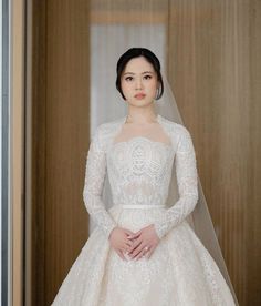 a woman in a white wedding dress and veil