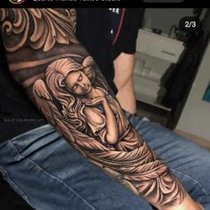 a man with a tattoo on his arm that has an image of a woman holding a baby