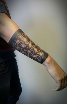 a man's arm with a tattoo on it that has an intricate flower design