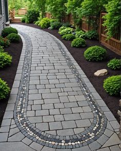 a brick walkway in the middle of a garden