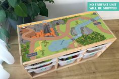 a children's wooden toy box with dinosaurs on it