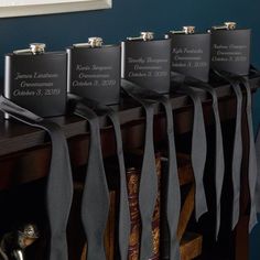 four flasks with ribbons tied around them on a table