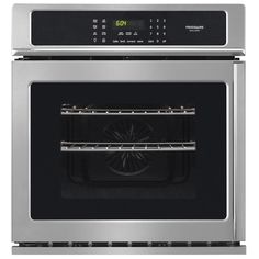 a stainless steel oven with the door open and an electronic clock on it's side