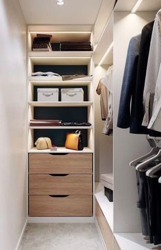 an organized closet with drawers and clothes