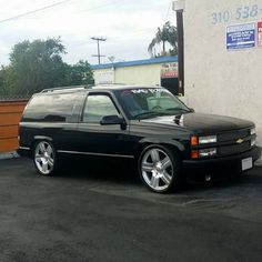 a black station wagon parked in front of a building