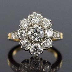 an old cut diamond cluster ring, set in 18ct yellow gold with brilliant diamonds