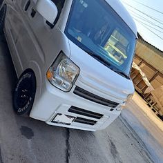 a white van is parked on the street