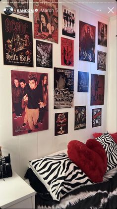 a bedroom with posters on the wall