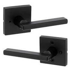 two black door handles with one handle open and the other closed on an isolated white background