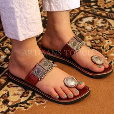 Handcrafted Leather Ethnic Slipper with Silver Toe Ring Detailing - Women's Silver Toe Ring Slippers  Description:  Step into a world of timeless elegance and comfort with our exquisite Handcrafted Leather Ethnic Slipper adorned with silver toe ring detailing, exclusively designed for women who appreciate style and tradition. These meticulously crafted slippers are the perfect blend of fashion, culture, and comfort, making them an essential addition to your footwear collection.  🌟 Key Features:  ✨ Handcrafted Excellence: Our skilled artisans put their heart and soul into creating each pair of these leather ethnic slippers. The result is a masterpiece of craftsmanship, featuring intricate detailing that reflects the rich heritage of traditional footwear.  ✨ Silver Toe Ring: The highlight o Bohemian Leather Toe Ring Sandals, Traditional Adjustable Toe Post Sandals, Traditional Hand Tooled Leather Sandals, Traditional Hand-tooled Brown Sandals, Traditional Brown Hand-tooled Sandals, Traditional Leather Toe Loop Barefoot Sandals, Traditional Leather Barefoot Sandals With Toe Loop, Traditional Sandals With Adjustable Single Toe Strap, Traditional Open Toe Toe Ring Sandals For Festive Occasion