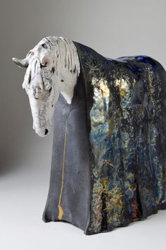 a sculpture of a horse is shown on a white background