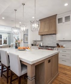 a large kitchen with an island in the middle