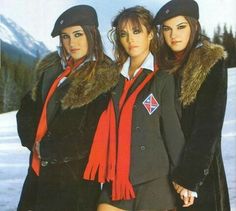 three young women in winter clothes posing for a photo on the cover of an magazine