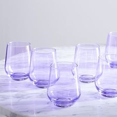 purple glasses lined up on a marble table