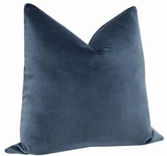 a blue velvet pillow with a square shape